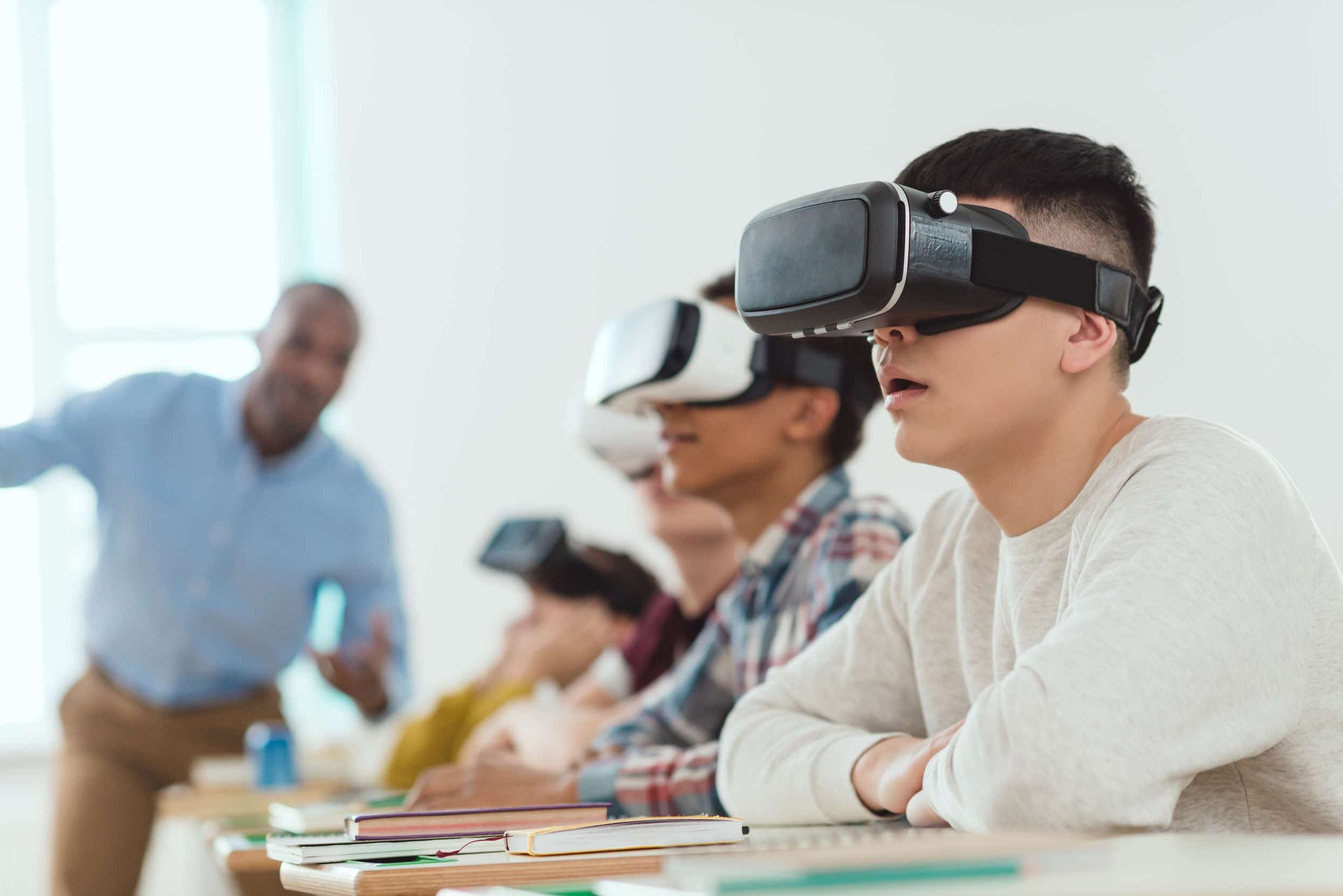 Young people using VR goggles in a classroom