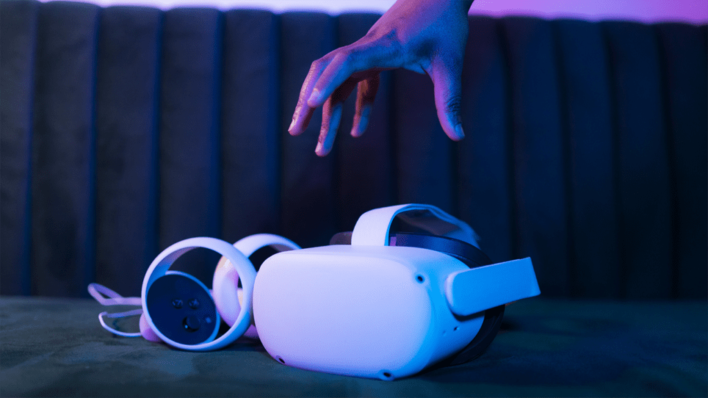 Hand reaching for VR headset and controllers