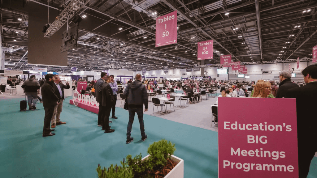 BET Education's BIG Meetings Programme - view of exhibition centre with rows of tables and people meeting