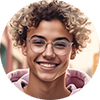 AI generated image of "Jordan" the Personal Learning Coach. Jordan has a clean, modern look—short-cropped curls, clear glasses, and a soft neutral-toned hoodie. Their style is casual but confident, with calm eyes that signal focus and reassurance. They move with a quiet energy, like someone who always has time for you and genuinely wants you to succeed.
