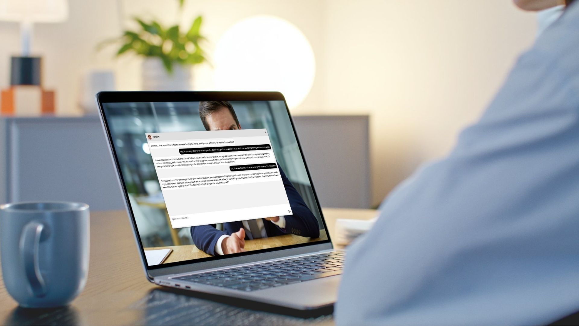 Over the shoulder shot of someone at laptop interacting with Aidan, the AI Agent.