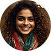AI generated image - Riya – The Goal Tracker & Progress Partner Riya exudes positive energy. She wears a bright, patterned scarf over a solid top, with natural curls tied back and animated eyes that light up when celebrating your progress. Her smile is frequent and sincere. She’s the type of person who always brings a sense of momentum into the room.