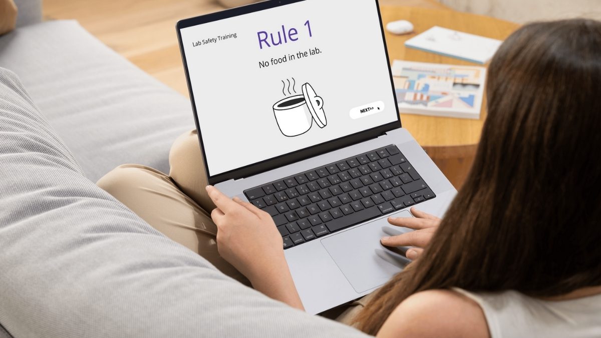 Over the shoulder view of woman on sofa with laptop. Laptop show uninspired training course.