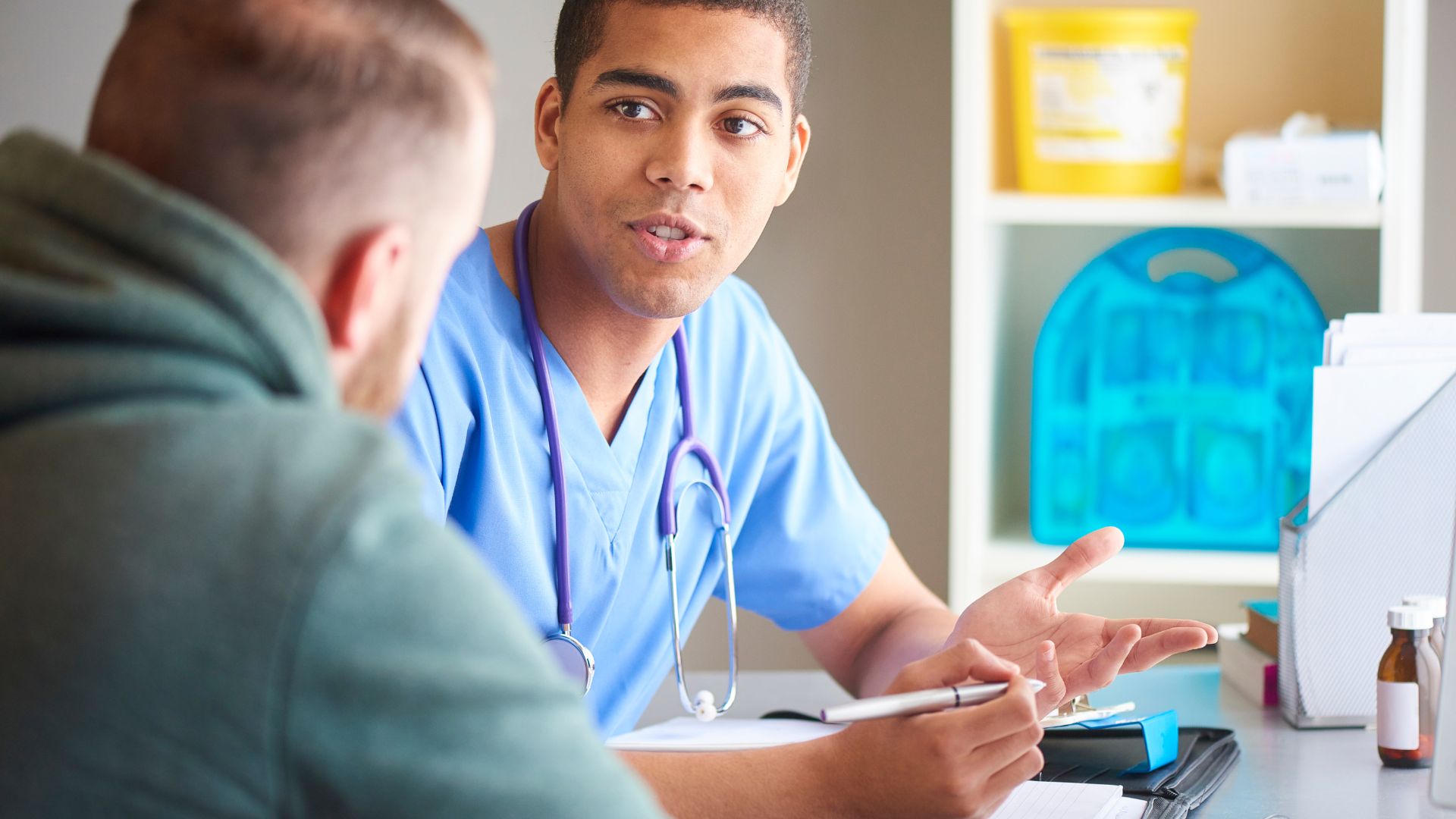 A patient and doctor in conversation in doctor's office.
